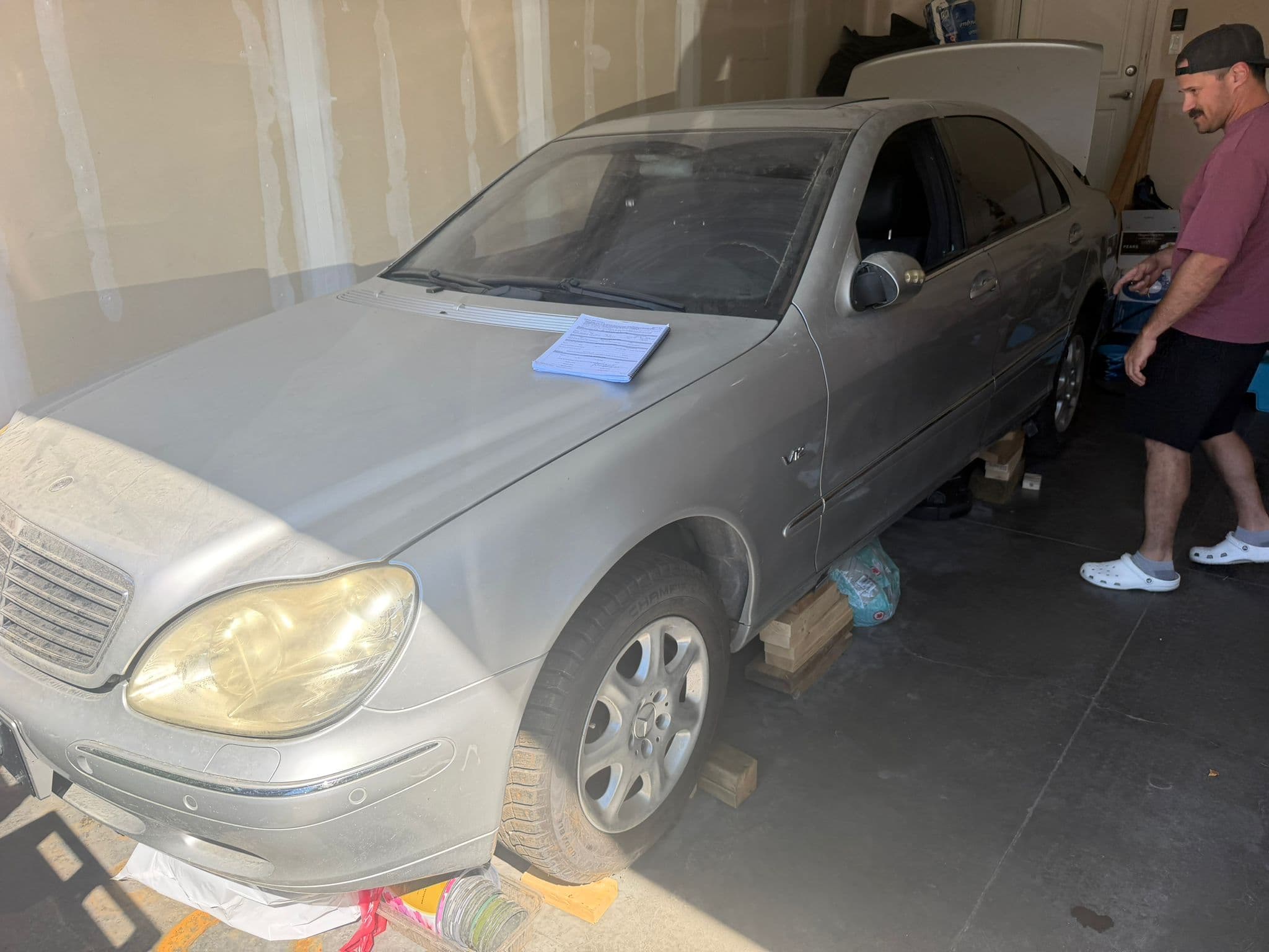 Silver Mercedes and sale paperwork prepared in a Calgary garage